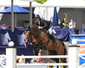 Nick Skelton and Big Star soar over a jump.