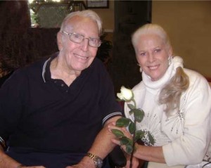 Tish holds a white rose as the two celebrate Valentine's Day.