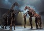 Puppeteers assist their equine charges in a rearing battle in the stage production of "War Horse."