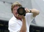 Photographer Michael J. Marten staring down a massive telephoto lens.