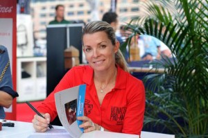 Edwina Tops-Alexander signs a copy of her book, "The Winner of Oz."