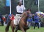 Sheikh Mohammed Bin Rashid Al Maktoum rides his horse across the finish line in the rain.