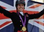 Charlotte Dujardin, individual dressage gold medalists, poses before her nation's British flag.