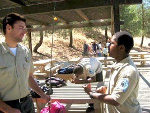 A mountain ranger talks shop with a junior ranger.