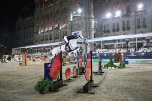 Pénélope Leprevost and her striking grey horse, Mylord Cathago, clear a huge oxer against a backdrop of Vienna's historic Rathaus building.