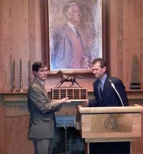 Tim Capps hands Tom Struzzieri his award.