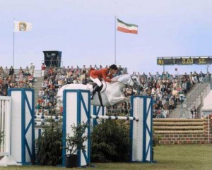 Conrad Homfeld and his grey stallion Abdullah sail over a jump in Aachen.