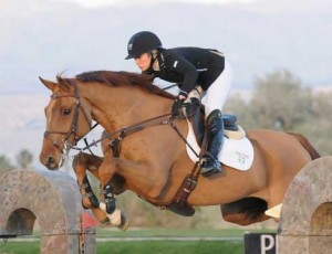 Ashlee Bond soars high in the air on the back of Cadett 7.