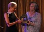 Portia de Rossi accepts her bronze trophy from Mayisha Akbar.