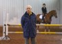 Olympian Joe Fargis strikes a pose in front of a vertical with horse and rider.