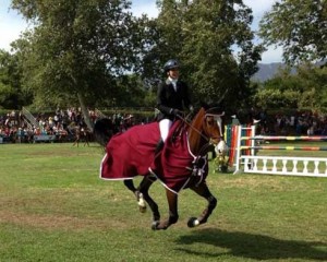 Susan Artes and Zamiro take their victory lap in a crimson cooler.