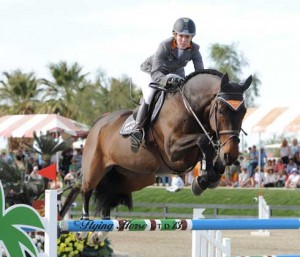 Meredith Michaels-Beerbaum and the bay mare Bella Donna fly over a jump.