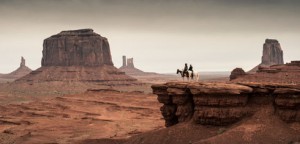 The Lone Ranger and Tonto, mounted at a precipice in Utah's Monument Valley.