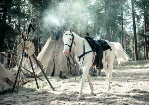 Silver strolls through an Indian emcampment.