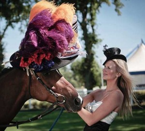 A horse in a large brightly-colored hat by Stephen Jones.