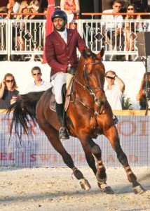 Bassem Hassan Mohammed rides a bay horse.