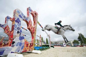 RH Prince Abdullah Bin Miteb and Davos fly over the brightly-colored Gaudi jump.